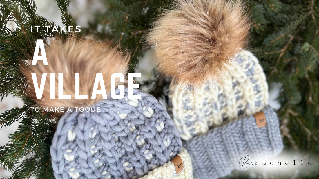 A Blog Banner Image Displaying Two Knit Beanies with Folded brims & poms poms laying in a spruce tree. Text Reads: It Takes a Village to Make a Toque.